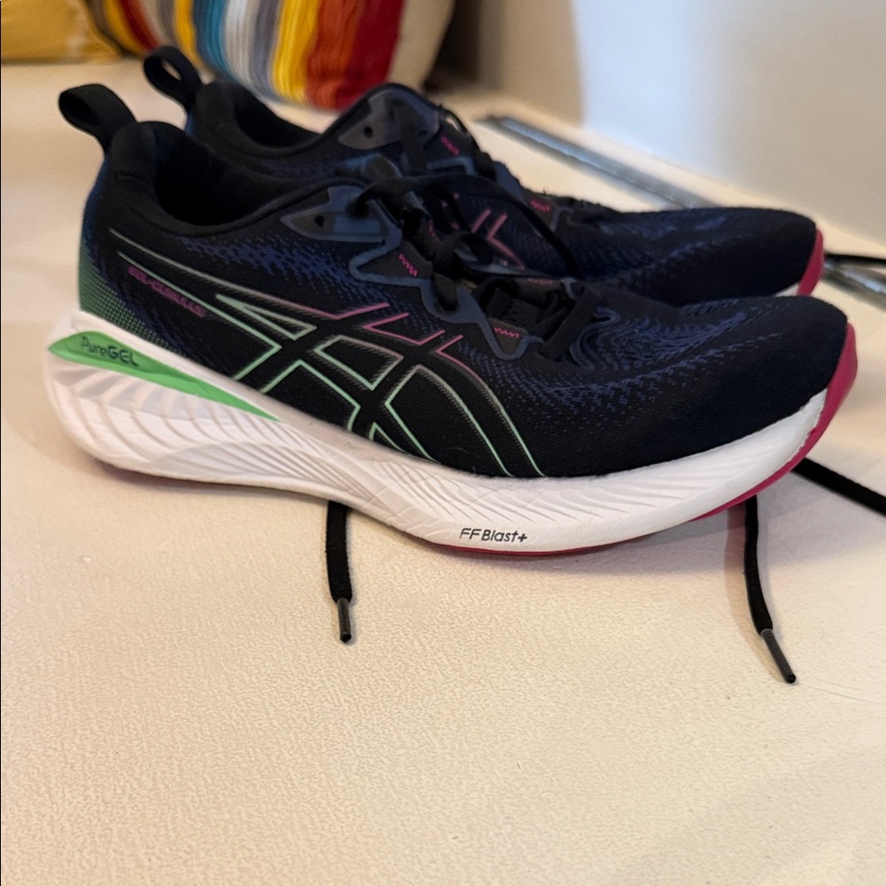 Women’s ASICS Gel Cumulus 25 Black Running Shoes with Mint Green & Pink Accents.